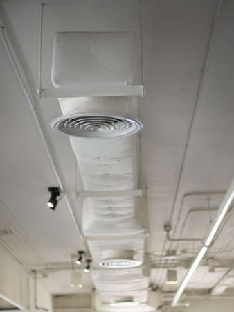 Air Ventilating tube installed on the ceiling of the office building or mall.の写真素材