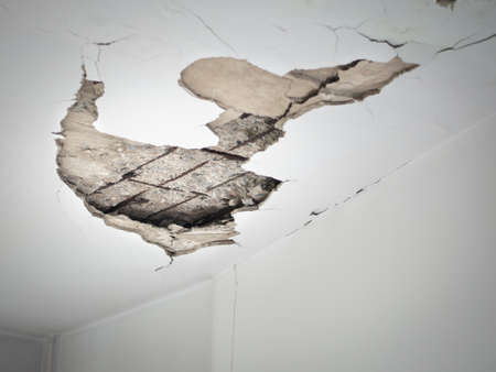 Cracks in the ceiling from the water pipes seeping inside the building.の写真素材