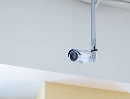 Small CCTV camera security mounted on the ceiling, Inside the building