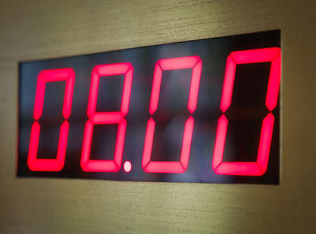 Digital clock face shows 8 o'clock in the morning or evening.の写真素材
