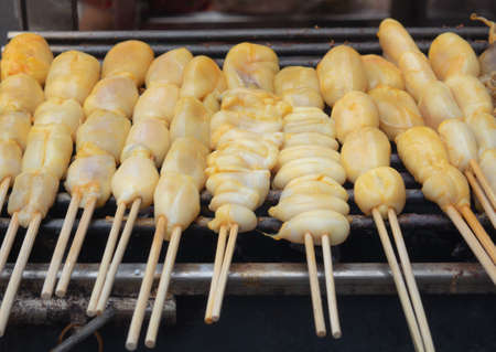 Fresh squid eggs on skewers and grilled over charcoal for seafood and barbecue.