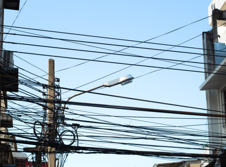 Wire and cable clutter, The chaos of cables and wires on every street in Bangkok, Thailand.の写真素材