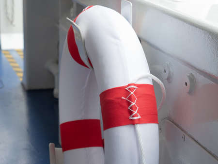Lifebuoys for passengers on boarding ships are mounted on the side of the boat.の写真素材
