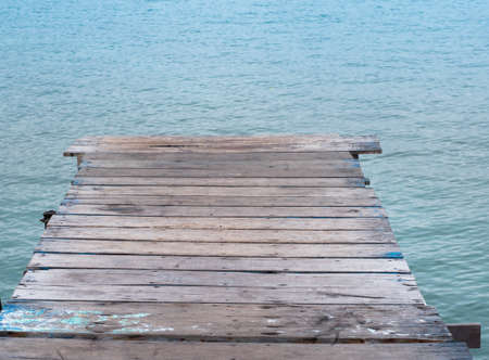 Fisherman's wooden log terrace leading into the sea.の写真素材