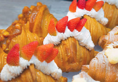Fresh Fresh croissants topped with fresh strawberries.