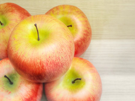 Red and yellow apples on a wooden backgroundの写真素材