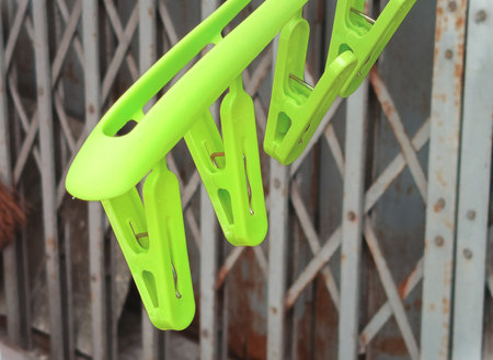 Close-up of green plastic clothes pegs
