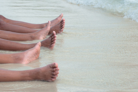 Leg and friendship at the beachの写真素材