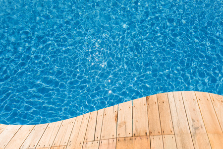 Blue swimming pool with a plank curve