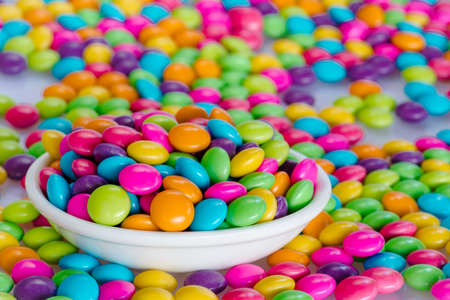 Colorful candies on the white ceramic bowlの写真素材