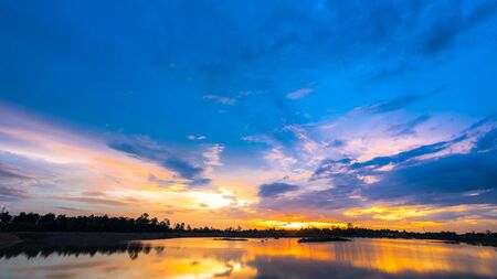 Sunset landscape with blue sky over the calm lakeの写真素材