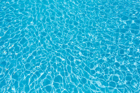 Ripple water surface and sun reflection in swimming pool