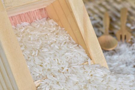 Closeup jasmine rice with wooden containerの写真素材