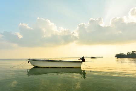 Canoe floating on the calm sea in morningの写真素材