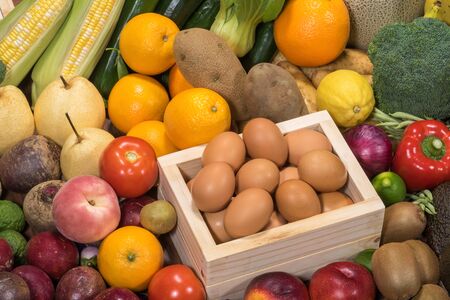 Set of different raw food for healthy, Fresh Fruits with Fresh vegetables and eggs in container, Prepared raw food foor cookingの写真素材