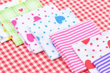 Stack of Multicolor napkin with checkered fabric on the tableware