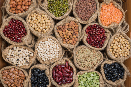 Various colorful dried legumes in sackcloth  for backgroundの写真素材