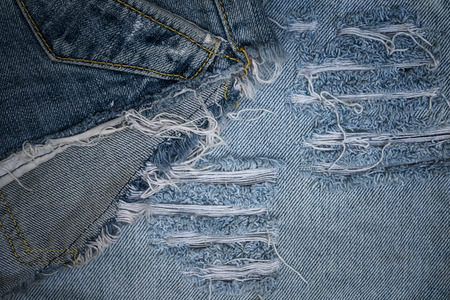 Old jean texture with a holeの写真素材