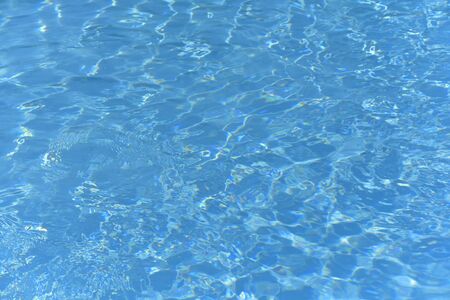 Blue and bright ripple water and surface in swimming pool , Beautiful motion gentle wave in pool