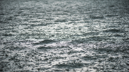 Raindrop impact on rippling water surface