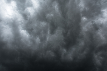 Dark sky and black clouds before rainy high contrast, Dramatic black cloud and thunderstormの写真素材