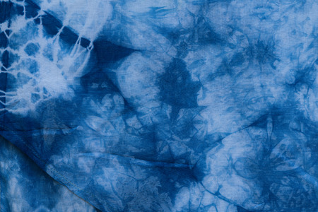 Dyed indigo fabric background and textured, Painted blue watercolor on white cotton clothの写真素材