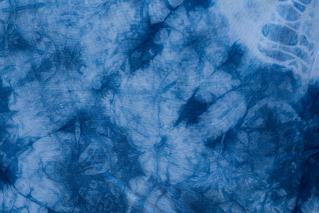 Pattern of blue tie batik dye on cotton cloth, Dyed indigo fabric background and textured, Painted blue watercolor on white cotton clothの写真素材