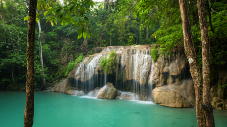 Breathtaking green waterfall at deep forest, Erawan waterfall located Kanchanaburi Province, Thailand の写真素材