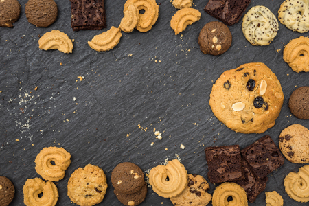 Top view different cookies on table top, Flat lay of various cookies on black stoneの写真素材