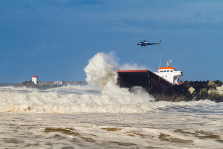 ANGLET, FRANCE - FEBRUARY 5: The spanish cargo Luno broken into two parts stuck in front of a breakwater at the entry of the Anglet port february 5, 2014 in Anglet, FRANCE.のeditorial素材