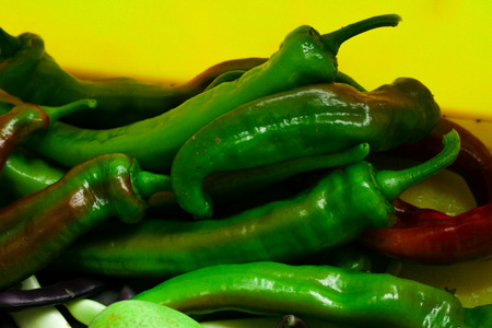 Some chillie peppers and beans that were just harvested.の写真素材
