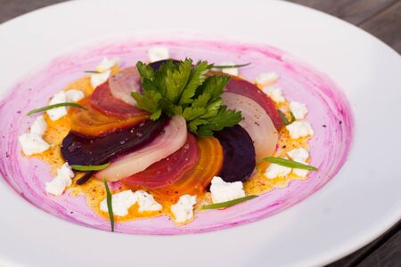Three roasted beets with goat cheese, chives, and turmeric dressing.の写真素材
