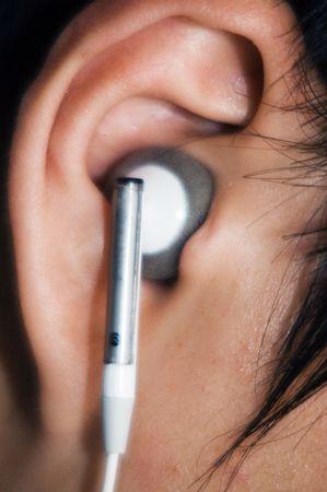A model listening to music with an earphone