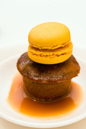Sticky pudding dessert in a plate with caramel sauce with marzipan decorationの写真素材
