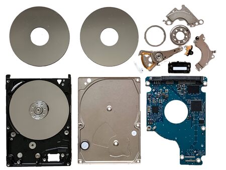 A dismantled hard disk drive laid out neatly showing all its componentsの写真素材