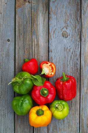 Food background. Fresh pepper on old wooden table. Cover for the book.の写真素材