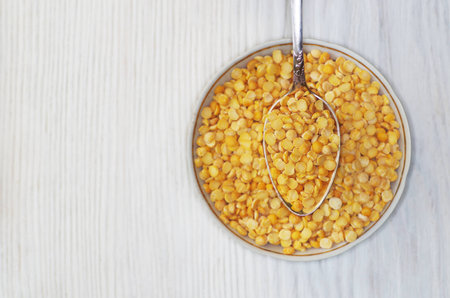 Organic dried peas in a ceramic bowl. Top view.