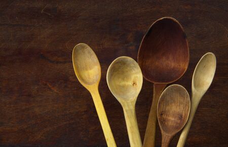 Cooking background. Still life of wooden spoons on a dark background.の写真素材