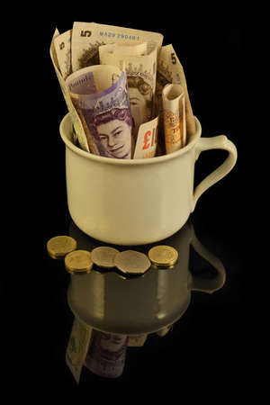 Savings in Pound Sterling, Pounds assorted bills, cash pile backgroundの写真素材