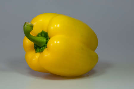 beautiful red tomatoes, yellow peppers in a group and individually