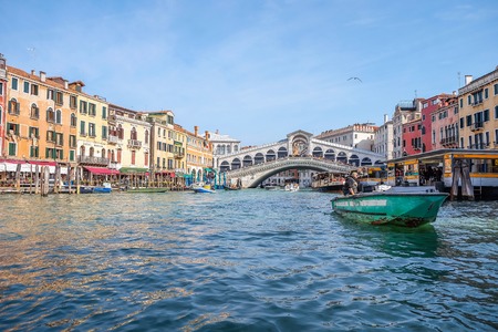 Venice, Italy - March 09, 2019: Tourists enjoy riding a boat and gondolas bypassing the city. Some of them sit in cafes and walk in nice weather at a popular tourist destination in Italyのeditorial素材