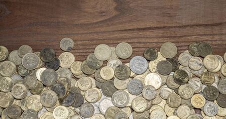 Background with metal coins scattered along the table