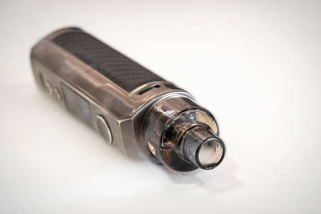 Close up of electronic cigarettes on a white background with smoke