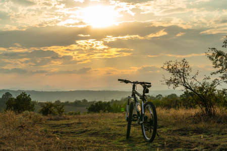 Bicycle on a mountain trail at sunset in natureの写真素材