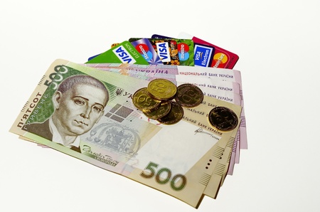 Credit cards, paper money and coins on white background  Ukrainian money のeditorial素材