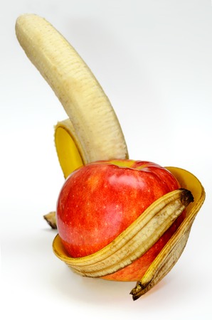 Apple in the arms of a banana on white background  Healthy lifestyle の写真素材