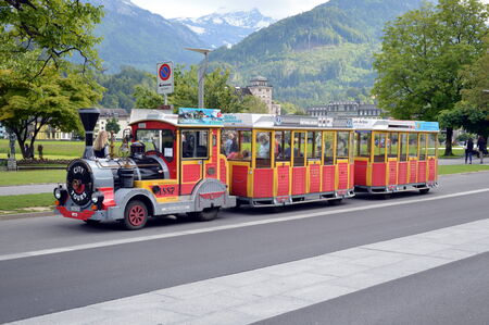 city tour by mini train on street of Interlaken Switzerlandのeditorial素材