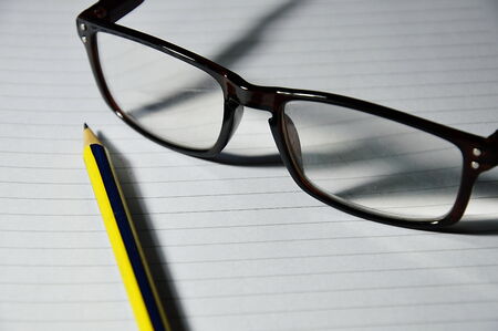 glass and pencilの写真素材