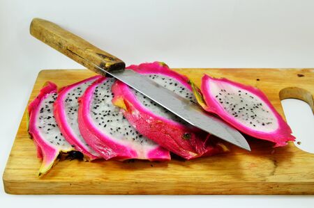 dragon fruit and knife on chopping block
