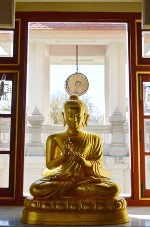 golden Buddha and big drum in a Buddhist templeの写真素材